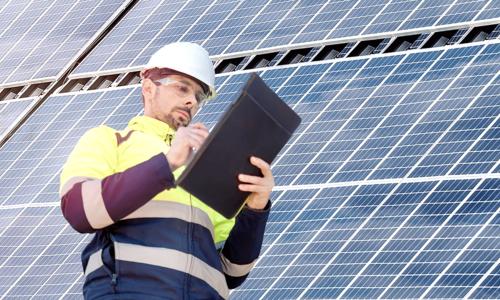 Attractive engineer installing solar panels and clean energy