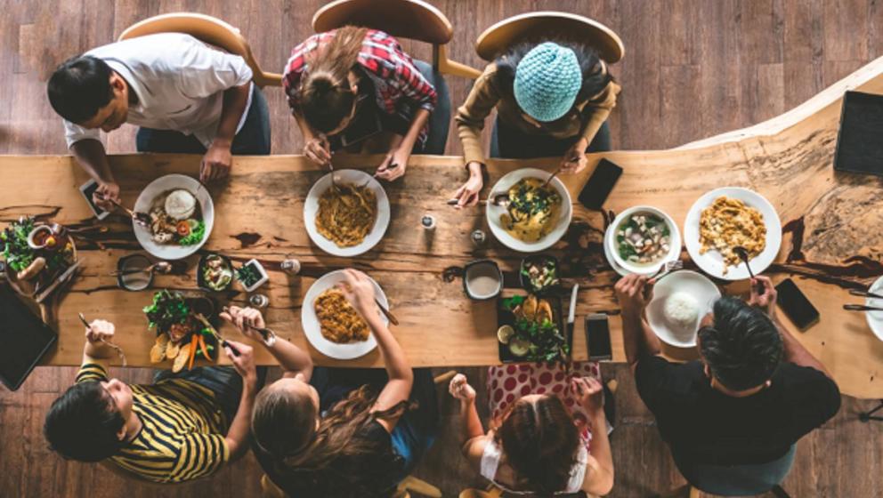 Family having lunch on a wood table