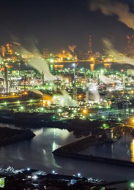 a worker with his computer in front of a factory