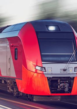 Modern high-speed train traveling along railway tracks
