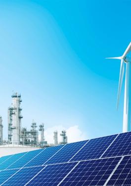 Solar panels and wind turbine supporting sustainable energy in an industrial environment.
