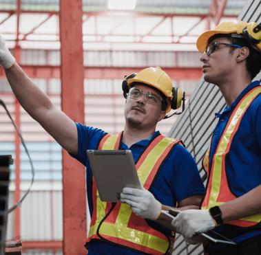 Industrial personnel inspecting machinery to support safety, compliance, and operational reliability.
